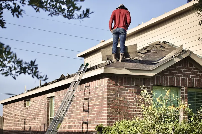 Professional roofer working on a residential roof in Fox River Valley Gardens